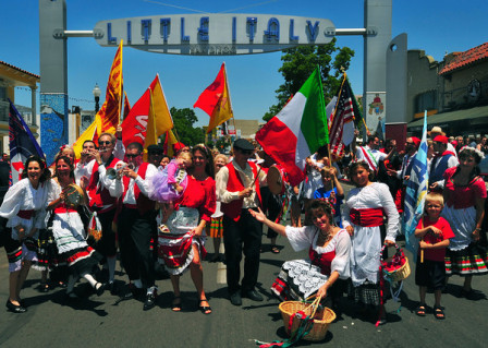 The Roman Holiday Ensemble poses underneath the Little Italy sign during the annual procession of the Festa Siciliana.