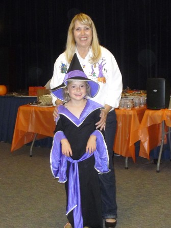 Sabrina Klestinec (age 6) is pictured with teacher Ms Wilson, who worked the Cake Walk at the last Harvest Festival.