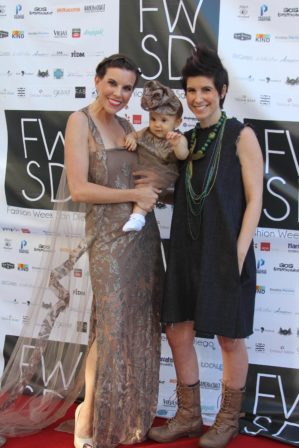 Allison Andrews (left) and Baby B wearing gowns by Pashn by Survi.  Aubree Lynn is wearing an Oseas Villatoro dress from the denim collection and jewelry (metal starfish and beaded necklace) by Artemisa Rivas. Photograph is by Diana Delzio Photography.