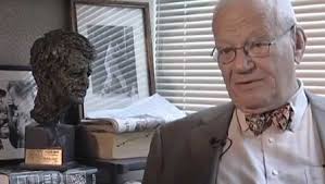 Frank Mankiewicz is  pictured next to a bust of Robert Kennedy. 