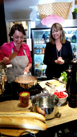  Virginie Woo (left) prepares a dish while Melissa Scott Clark, proprietor of Luxury Farms™, closely observes.  