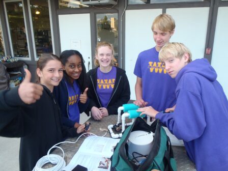 SeaPerch Club team members gather around a project. 
