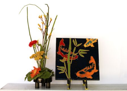 Artist Kathy Waller displays her work next to floral designer Marj Myers of the San Carlos Garden Club.