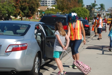 Cone zone guards assist students in and out of vehicles.