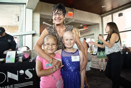  ENF Co-Founder Diane Nares is shown embracing eight-year old Esmeralda Mendez de Leon (L) and 10-year old Kimiko Schroeder (R). 