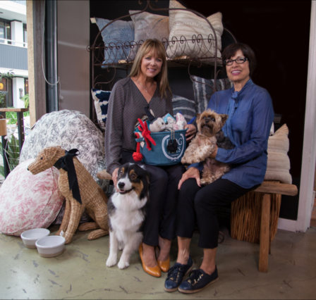 Pictured left to right are Luxury Farms co-owner Melissa Scott Clark, with Lucy. She sits next to Manager Julie Santa Cruz with Max. Santa Cruz is in charge of “Presents for you Pooch” in Mission Hills and Coronado stores and will custom design all pet gifting for the holiday 