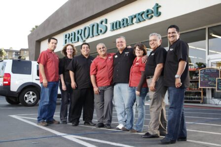 Baron’s management team gathers before a local store. 