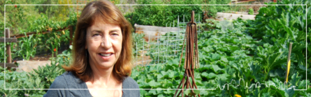 Trish Waitlington stands among the garden that she tends to and provides fruits and vegetables to her restaurants. 